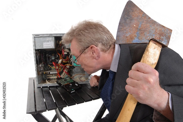 Obraz Angry businessman approaching a computer with an axe