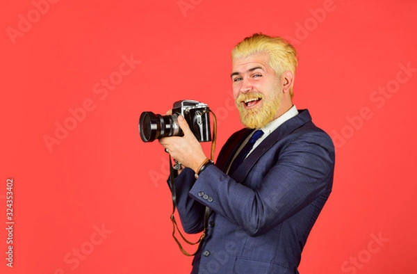 Fototapeta Vintage style trend. Classy and old school. Content creator. Man cheerful bearded hipster photographer. Photographer eccentric guy with slr camera. Manual settings. Photographer with beard mustache