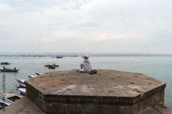 Obraz Portrait of sadhu or holy man praying and meditating on Ghats of Varanasi, India