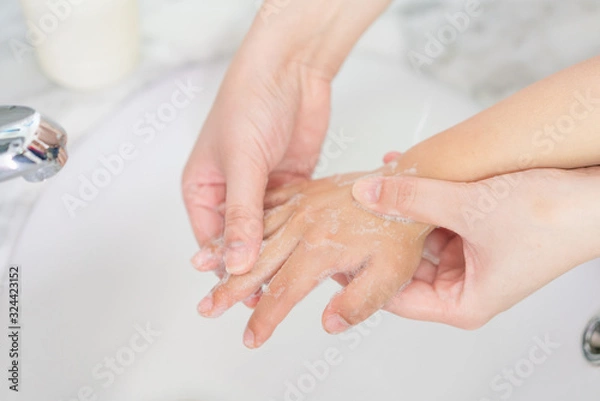 Fototapeta Young asian woman washing hands for her son
