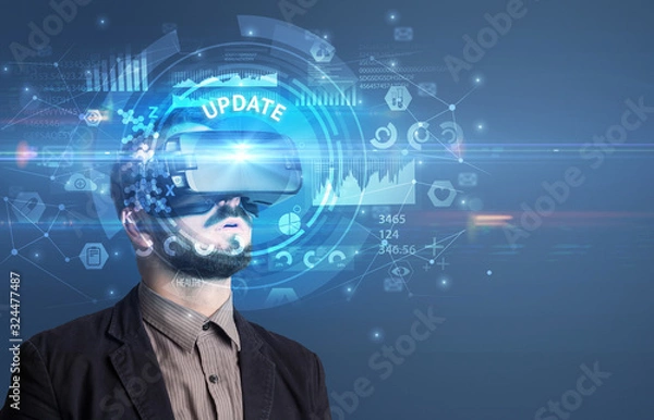 Fototapeta Businessman looking through Virtual Reality glasses with UPDATE inscription, innovative technology concept