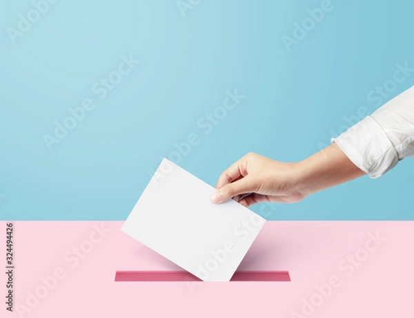 Fototapeta Hand holding ballot paper for election vote concept at blue backdrop. minimal composition concept.