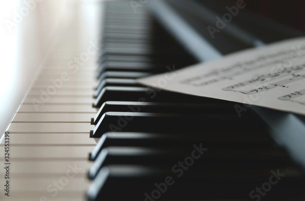 Fototapeta Keys of electronic piano, synthesizer, music instrument with sheet music  and notes    