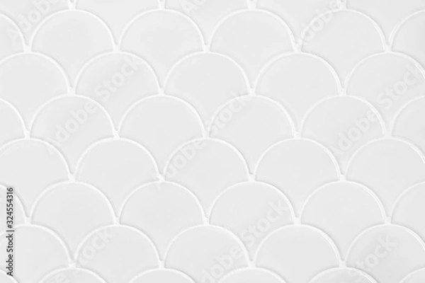Fototapeta White ceramic tiles in the form of scales. Mosaic Tiles on the wall