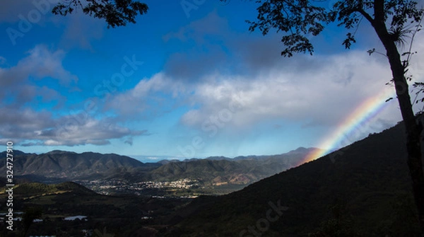 Fototapeta dramatic rainbow in caribbean mountains over San Jose De Ocoa, Dominican Republic,