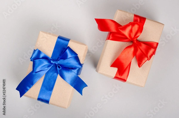 Fototapeta Gift box on gray background composition, present with ribbon and bow.