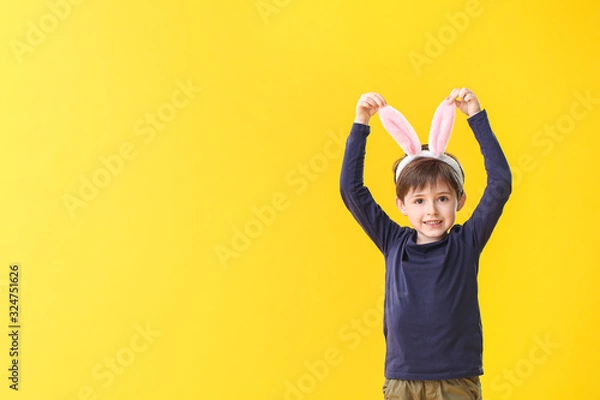 Fototapeta Little boy with bunny ears on color background