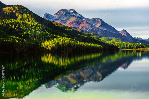 Fototapeta Mountain lake panorama with mountains reflection. Idyllic look. Autumn forest. Silvaplana Lake, Switzerland
