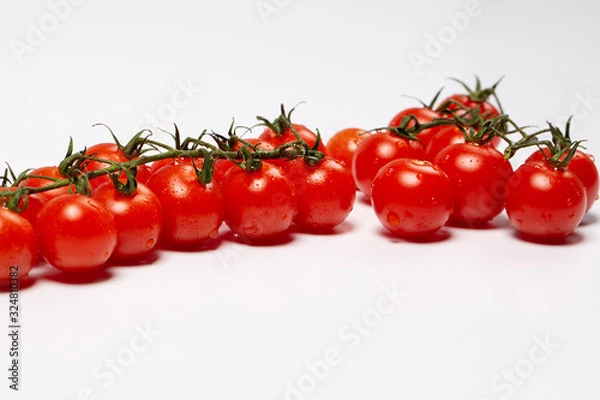 Obraz Cherry tomatoes covered drops on a white background