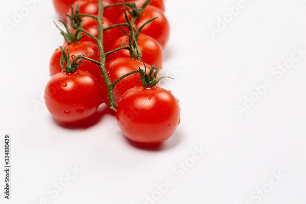 Obraz Cherry tomatoes covered drops on a white background