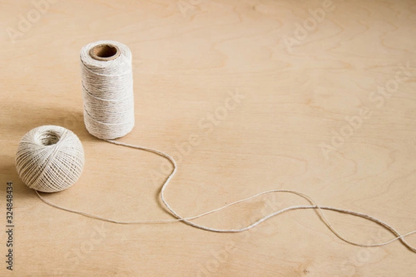 Obraz beige threads, twine on wooden background