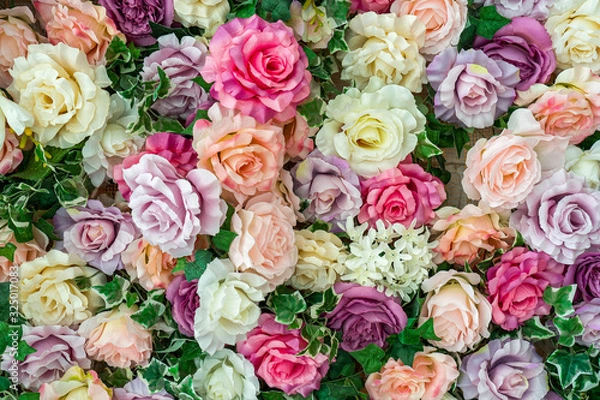 Obraz Closeup flatlay top view of many colorful artificial synthetic flowers of pastel red, pink, purple, white and orange colors.