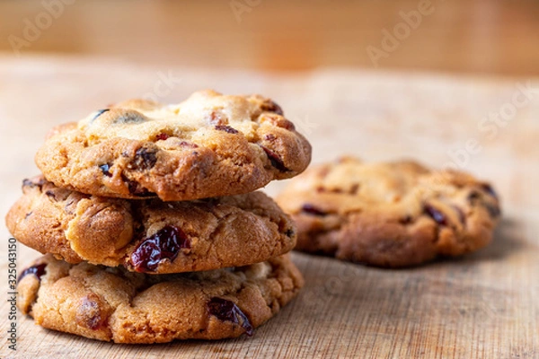 Fototapeta homemade cookies with cranberries and chocolate  on a wooden cutting board