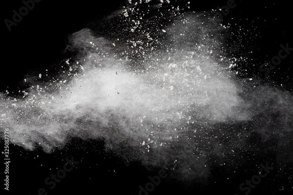 Fototapeta Freeze motion of white dust particles splash on black background.White powder explosion clouds.