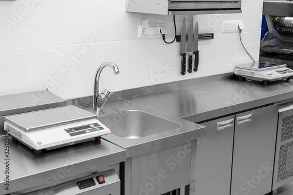 Fototapeta Design of the working area of the commercial cafe kitchen with stainless steel equipments, hot shop, food industry.