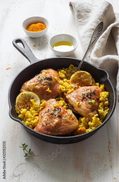 Obraz Fried chicken thighs with rice and chickpeas