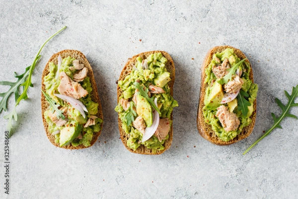 Fototapeta Avocado toast with tuna and arugula