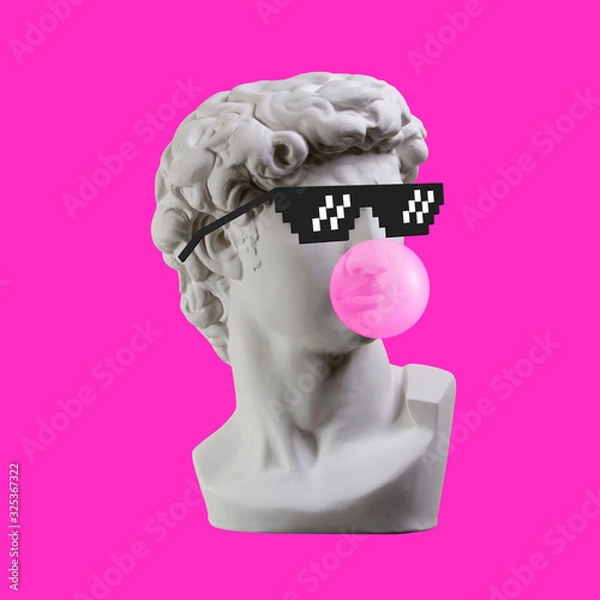 Fototapeta Statue. Earphone. Isolated. Gypsum statue of David's head. Man. Creative. Plaster statue of David's head in pixel glasses. Minimal concept art.