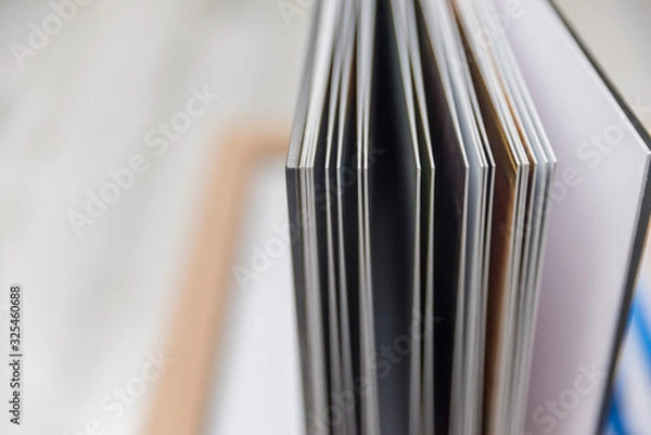Fototapeta Close up of thick and rigid wedding album pages in a book with acrylic cover
