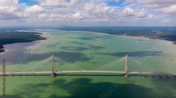 Obraz The Johor Bridge at the south of Malaysia from the sky. Cars passing by on the Bridge.  Pass the ocean bay near the city of Singapore. The Highway ends at Desaru Coast, holiday resort for Singaporeans