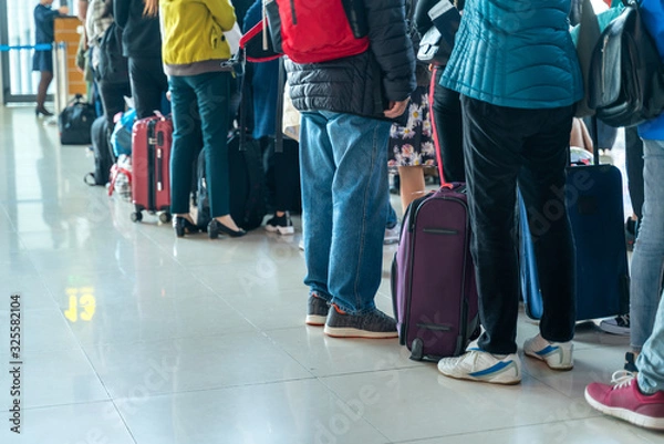 Obraz Line of Asian people waiting at boarding gate at airport