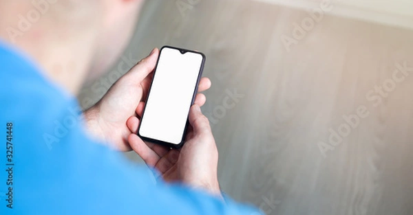 Fototapeta Mockup image of hand holding mobile phone with blank white screen