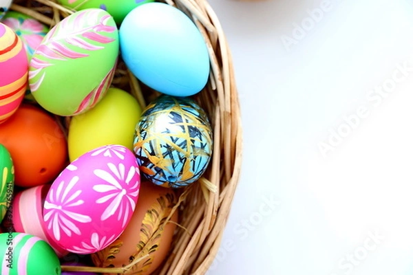 Fototapeta easter eggs in basket on white background