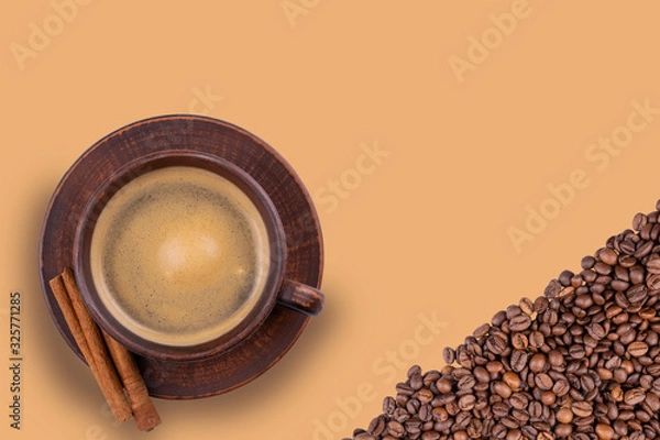 Fototapeta a Cup of coffee and coffee beans on an isolated background close up view from the top