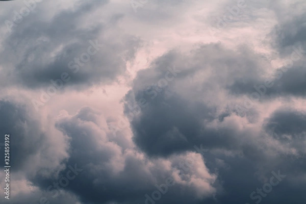 Obraz Grey stormy clouds in sky on sunset.