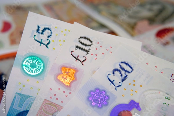 Obraz New British polymer money. The banknote 5, 10, 20 Sterling Pound notes which released by February 2020 in the United Kingdom.