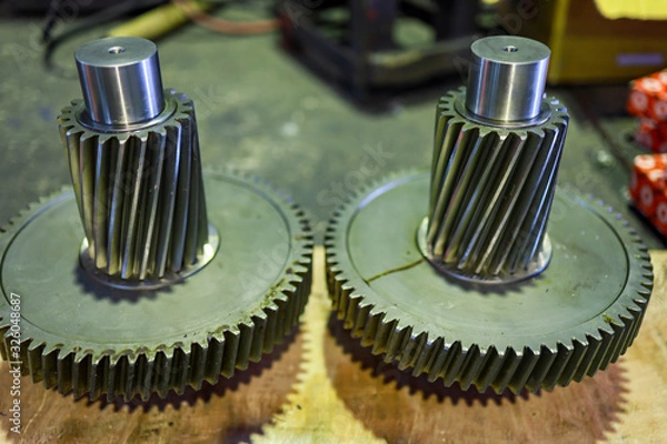 Obraz gear wheels and shaft gear on floor wait for assembly