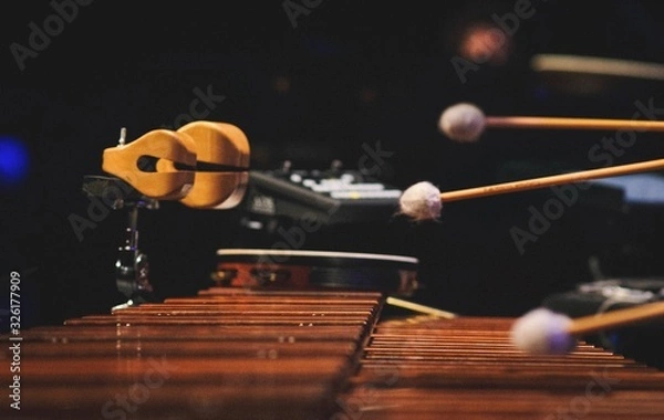 Fototapeta A man playing a marimba on a concert stage
