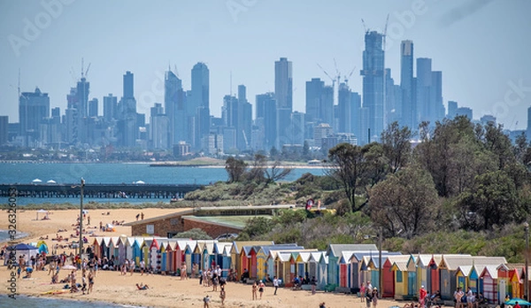 Fototapeta View from above of Brighton Beach huts in front of Melbourne Skyline