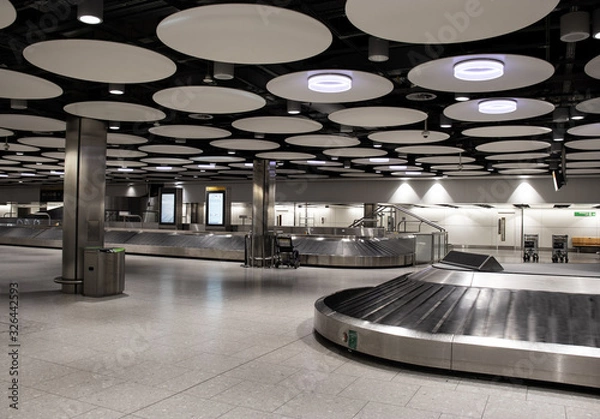 Obraz Empty baggage carousel conveyor at the baggage collection hall in Terminal, Heathrow Airport, London. Heathrow is the main airport serving London.