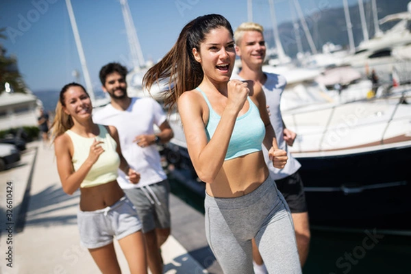 Fototapeta Healthy group of friends running and enjoying friend time together