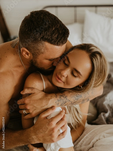 Obraz Beautiful loving couple kissing in bed