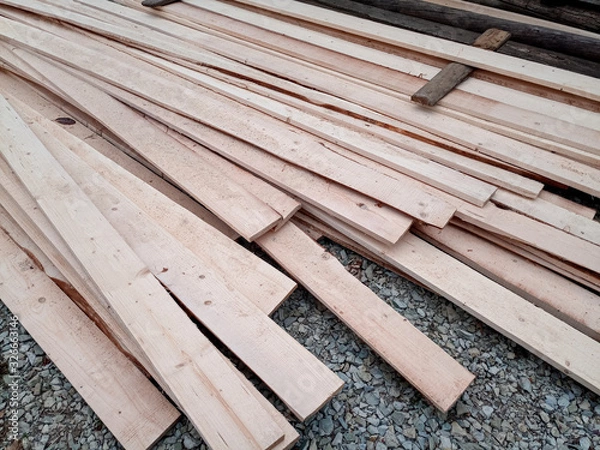 Fototapeta Boards with sawmill. Building material from wood, boards for construction.