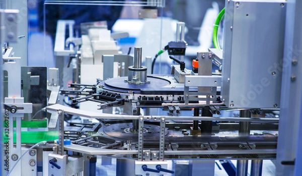 Fototapeta pharmaceutical industry. Production line machine conveyor at factory with bottles