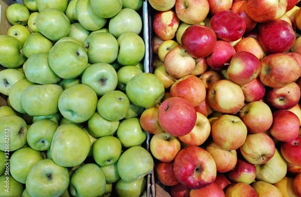 Fototapeta apples of different varieties in a box on shelves in a supermarket