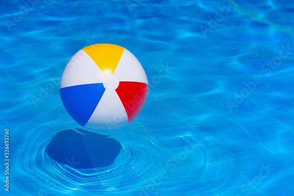 Fototapeta Colorful inflatable ball floating in swimming pool