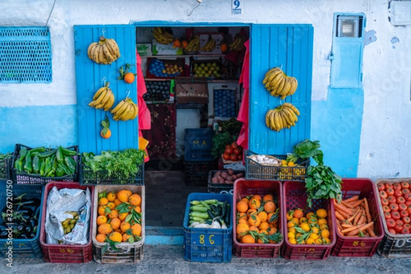 Fototapeta Plenty boxes of fresh fruits and vegetables in the blue city Chefchaouen in Morocco during spring time, sunny day.