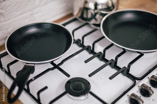 Fototapeta two clean pans on the stove
