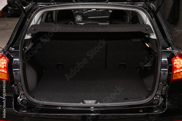 Fototapeta Rear view of a black car with an open trunk. Exterior of a modern car .