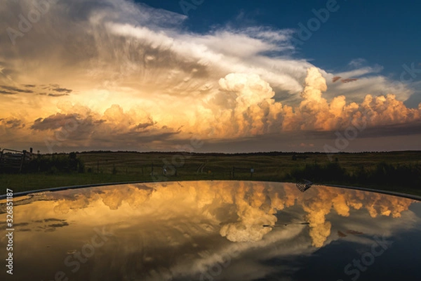 Obraz stormy sunset over a reflecting pool 