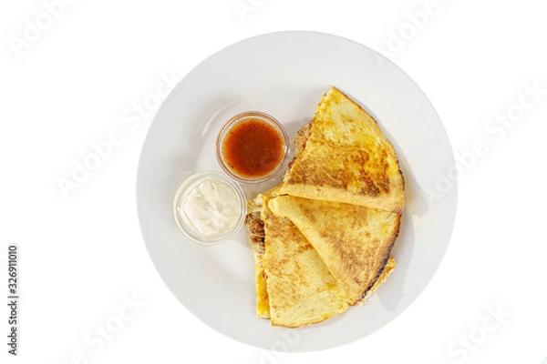 Fototapeta Quesadilla with minced meat and cheese, 3 slices, two sauces from tomatoes and sour cream, isolated white background, view from above