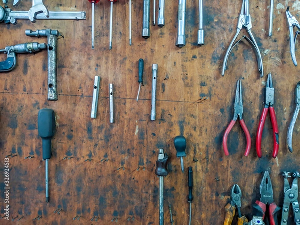 Fototapeta Mechanics tools for repairing an fixing organized on wooden panel board consisted of different sets of tools, like pliers and screwdrivers