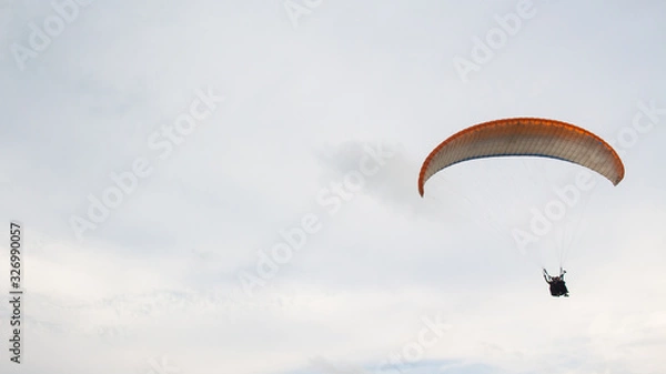 Fototapeta extreme paragliding sports are above the clouds