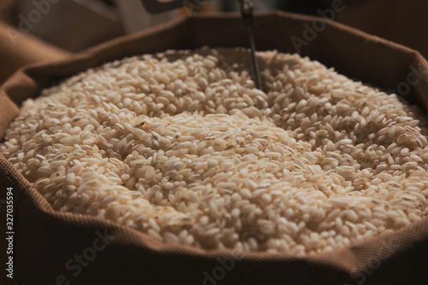Fototapeta Stock photo of a close-up of a sack full of rice at a market stall