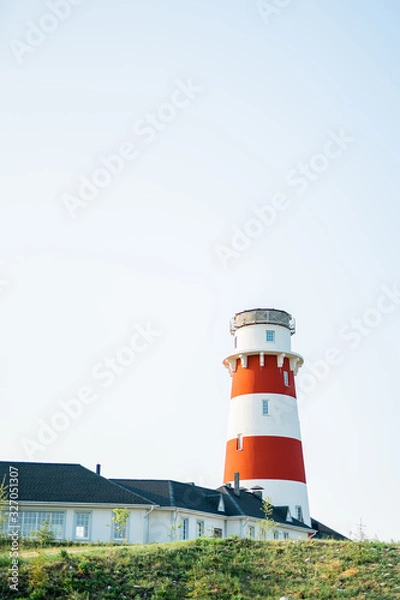 Obraz Lighthouse with house on the blue skies background