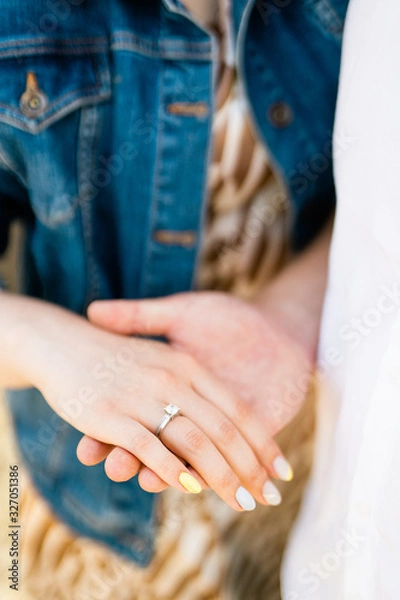 Obraz Hands of bride and groom with ring on finger